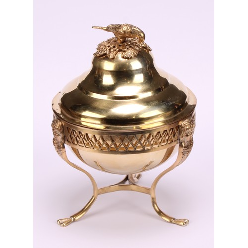 579 - A 19th century Continental silver-gilt sweetmeat box, the ogee cover crested by a parrot, the tripod... 