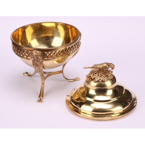 579 - A 19th century Continental silver-gilt sweetmeat box, the ogee cover crested by a parrot, the tripod... 