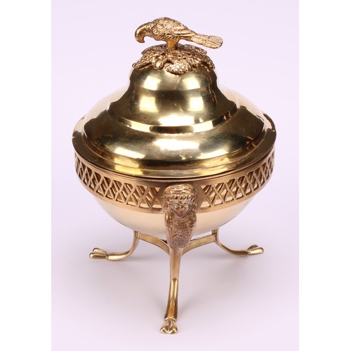 579 - A 19th century Continental silver-gilt sweetmeat box, the ogee cover crested by a parrot, the tripod... 