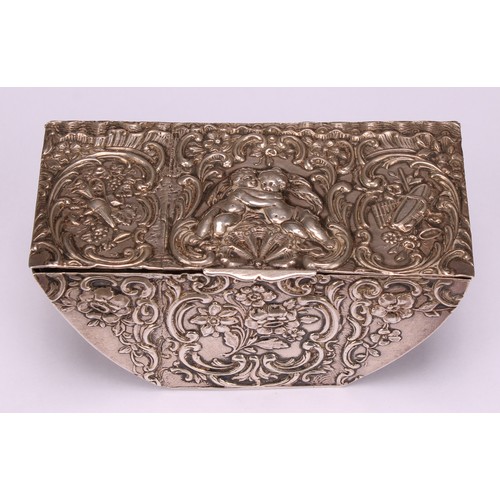 580 - A 19th century Dutch silver boat shaped table snuff box, chased with putti, Bacchic and musical trop... 