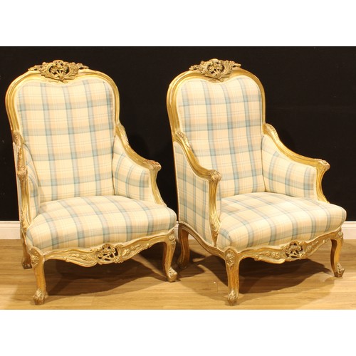 1274 - A pair of Italian giltwood armchairs, in the 18th century Rococo taste, shaped cresting carved with ... 