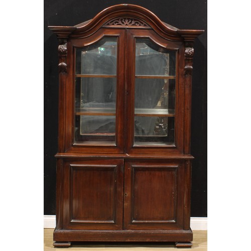 1441 - A Victorian mahogany shop display case or library bookcase, arched cornice above a pair of glazed do... 