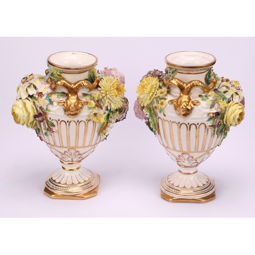 38 - A pair of John Bevington porcelain pedestal vases, of Neo Classical form, encrusted with flowers, gi... 