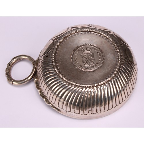 585 - A 19th century French silver wine taster, the chased and fluted bowl set with a Spanish coin, serpen... 