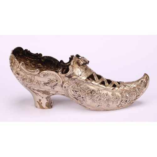 612 - A Dutch silver model, of a shoe, pierced, and chased with flowers and scrolls, on a textured ground,... 