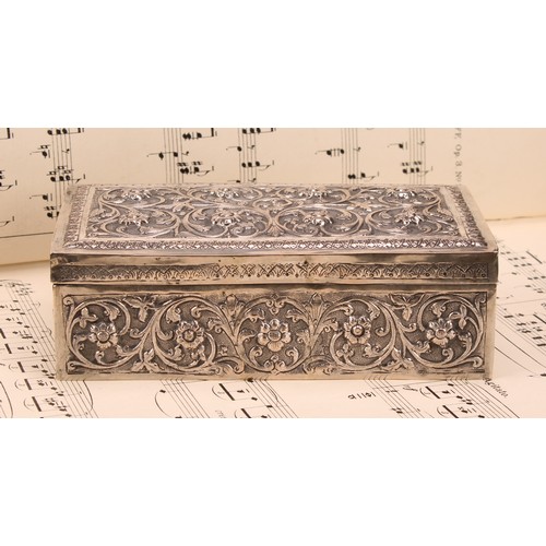 588 - A 19th century Indian silver rectangular box, chased with flowers and scrolling foliage, on a matted... 