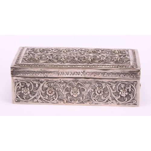 588 - A 19th century Indian silver rectangular box, chased with flowers and scrolling foliage, on a matted... 