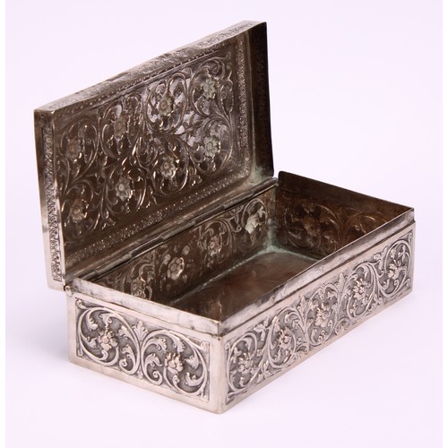 588 - A 19th century Indian silver rectangular box, chased with flowers and scrolling foliage, on a matted... 