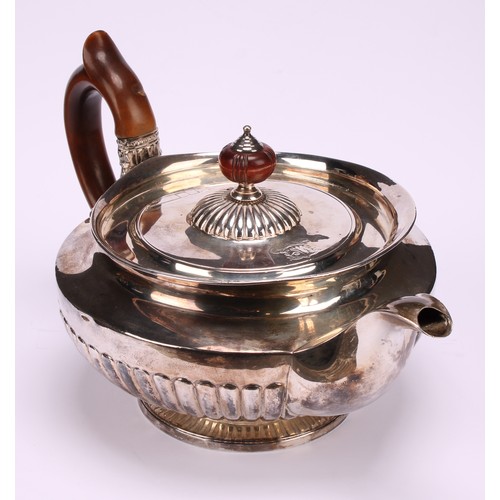 654 - A George IV silver half-fluted lamp shaped teapot, in the Regency taste, flush-hinged cover, scroll-... 