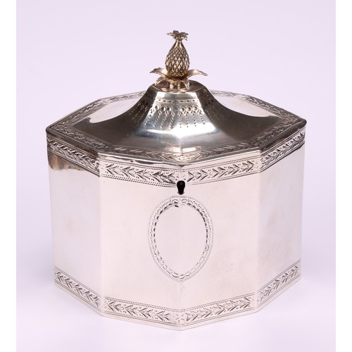 641 - A George III silver octagonal tea caddy, flush-hinged cover with pineapple finial, bright-cut border... 