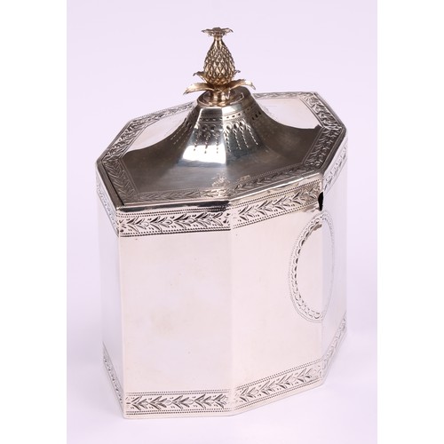 641 - A George III silver octagonal tea caddy, flush-hinged cover with pineapple finial, bright-cut border... 