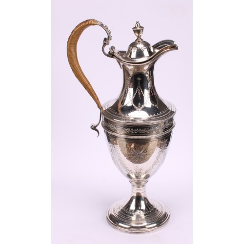 647 - A George III silver urnular pedestal wine jug, hinged domed cover with urnular finial, bright-cut en... 