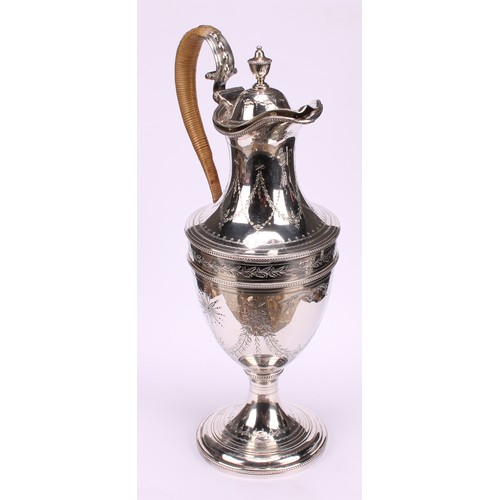 647 - A George III silver urnular pedestal wine jug, hinged domed cover with urnular finial, bright-cut en... 