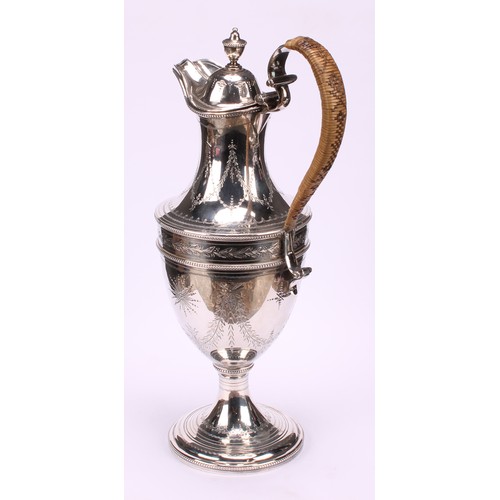 647 - A George III silver urnular pedestal wine jug, hinged domed cover with urnular finial, bright-cut en... 