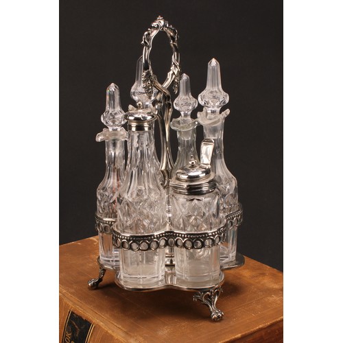 569 - A Victorian silver mounted six bottle cruet, posted leafy vine handle, hexafoil base, lion paw feet,... 