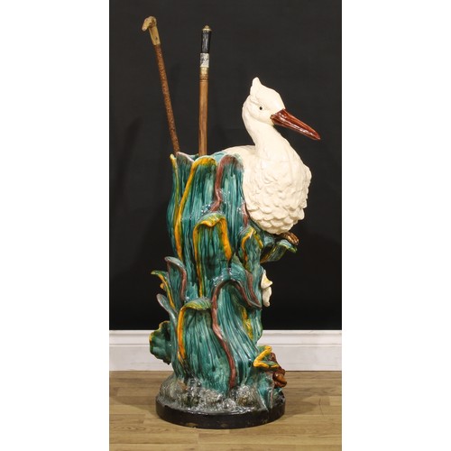 130 - A Continental majolica walking stick stand, in the manner of Minton, as a stork amongst hydrophytes,... 