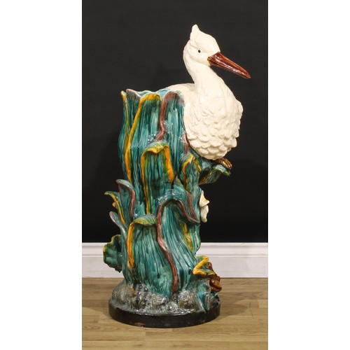 130 - A Continental majolica walking stick stand, in the manner of Minton, as a stork amongst hydrophytes,... 