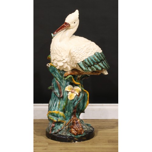 130 - A Continental majolica walking stick stand, in the manner of Minton, as a stork amongst hydrophytes,... 