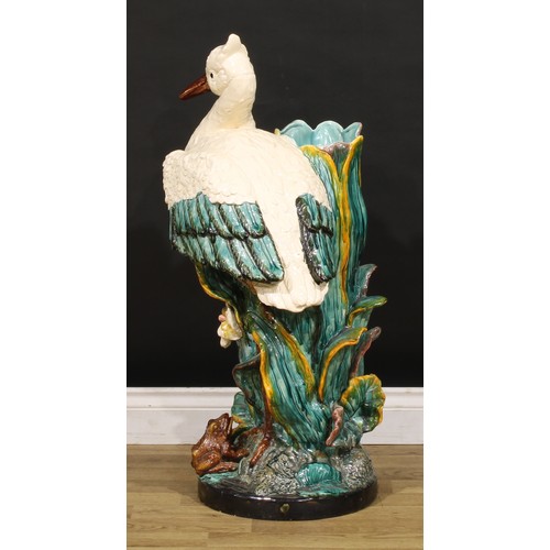 130 - A Continental majolica walking stick stand, in the manner of Minton, as a stork amongst hydrophytes,... 