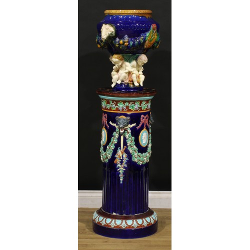 1452 - A Victorian Wedgwood majolica jardiniere pedestal, polychrome decorated and moulded with fruiting vi... 