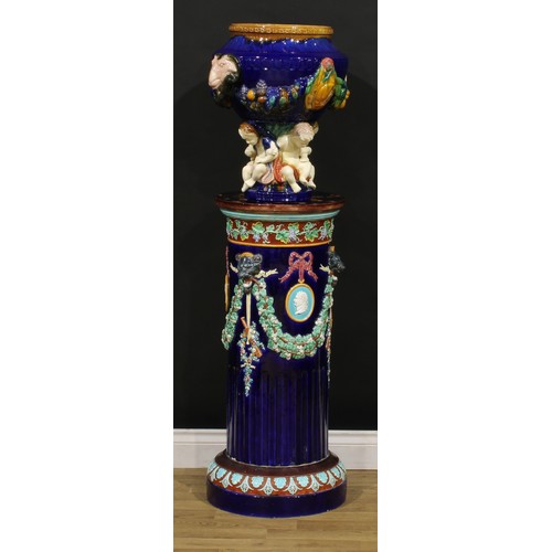 1452 - A Victorian Wedgwood majolica jardiniere pedestal, polychrome decorated and moulded with fruiting vi... 