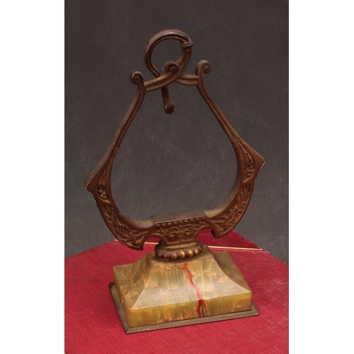 1910 - An early 20th century French gilt bronze and onyx pocket watch stand, of lyre outline, rectangular b... 