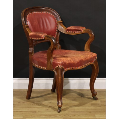 1870 - A Victorian walnut desk chair, cartouche shaped back carved with acanthus, stuffed-over upholstery, ... 