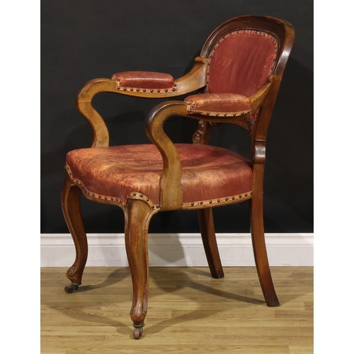 1870 - A Victorian walnut desk chair, cartouche shaped back carved with acanthus, stuffed-over upholstery, ... 