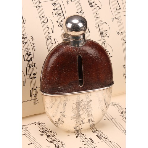 661 - A George V silver mounted leather-clad hip flask, hinged domed bayonet cover, stirrup cup to base, 1... 