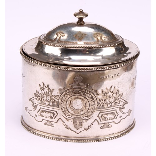 563 - A Victorian E.P.N.S oval tea caddy, bright-cut engraved with strapwork, leaves and flowers, hinged d... 