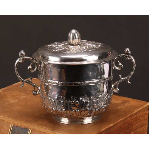 595 - A Charles II silver porringer and cover, chased with stiff acanthus, bun finial, pricked initials RP... 