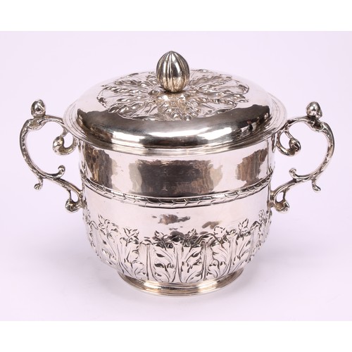 595 - A Charles II silver porringer and cover, chased with stiff acanthus, bun finial, pricked initials RP... 