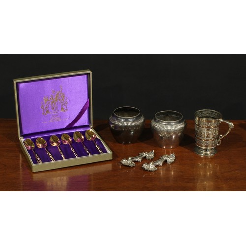 559 - A set of six enamel and gilt teaspoons, cased; a Victorian E.P.N.S christening mug, chased with Sign... 