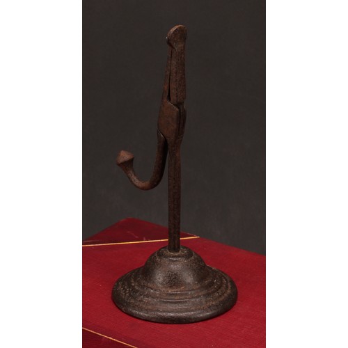 1906 - An 18th/19th century cast iron nip rushlight holder, domed base, 21.5cm high