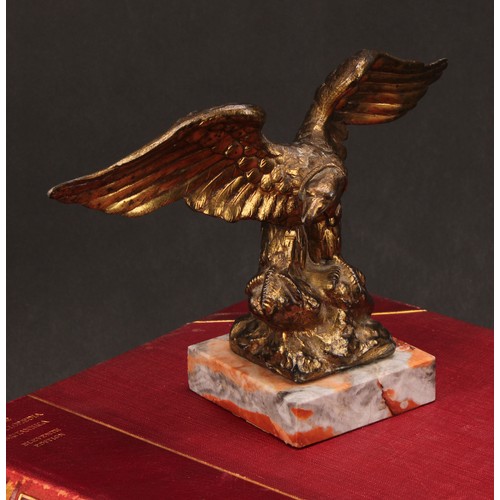 1911 - An early 20th century gilt metal novelty pocket watch stand, cast as an eagle grasping a snake, squa... 