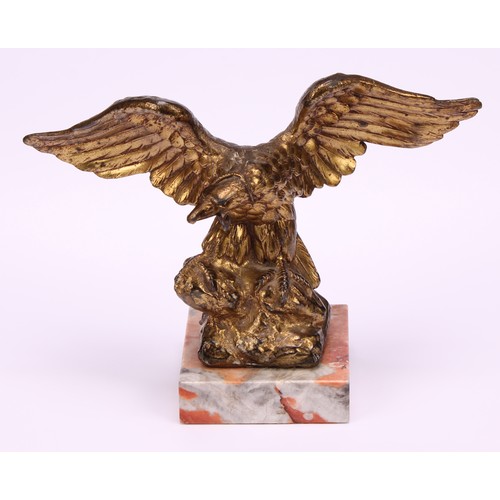 1911 - An early 20th century gilt metal novelty pocket watch stand, cast as an eagle grasping a snake, squa... 