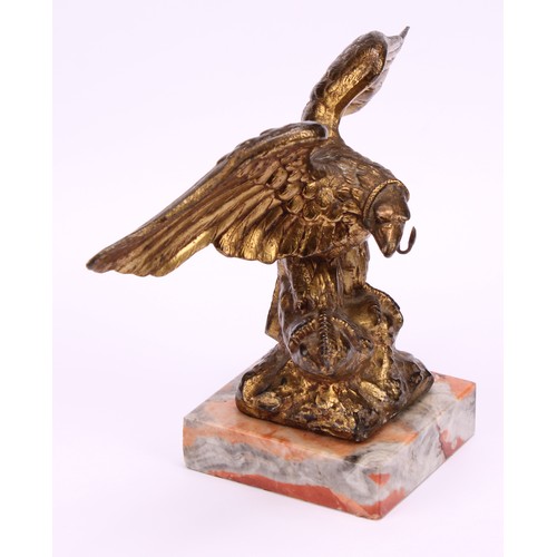 1911 - An early 20th century gilt metal novelty pocket watch stand, cast as an eagle grasping a snake, squa... 