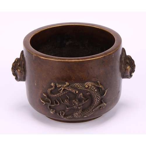 211 - A Chinese bronze censer, cast in relief with dragons chasing a flaming pearl, masks to sides, 13cm w... 