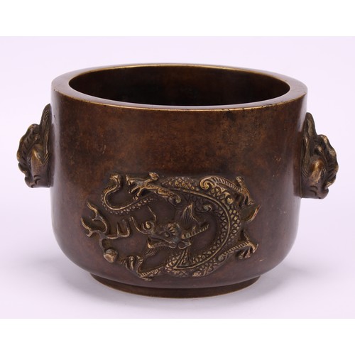 211 - A Chinese bronze censer, cast in relief with dragons chasing a flaming pearl, masks to sides, 13cm w... 