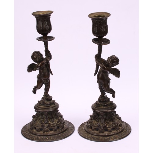 1569 - A pair of 19th century bronze figural candlesticks, cast in the renaissance revival taste as scantil... 