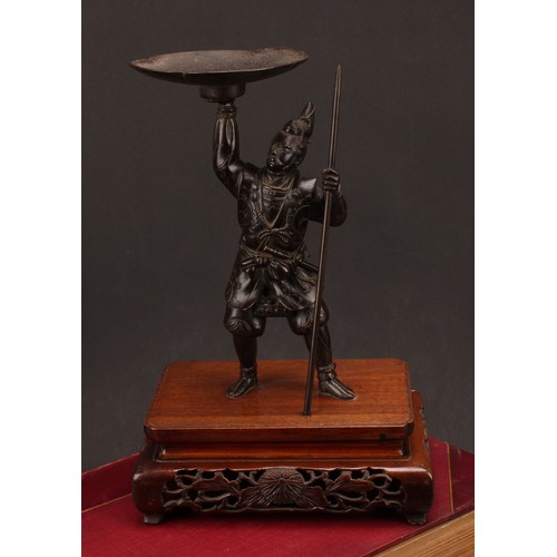 276 - Japanese School (Meiji period), a brown patinated bronze, of a samurai warrior, he stands holding al... 