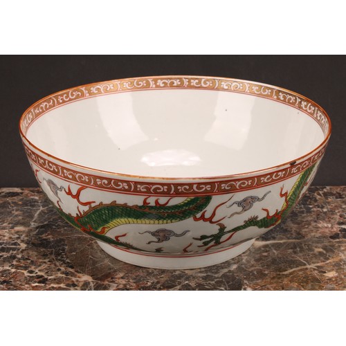 191 - A large 19th century Chinese punch bowl, decorated in polychrome enamels with scrolling dragons, the... 