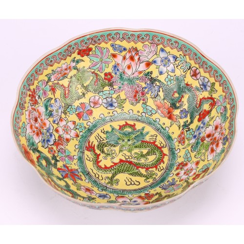 219 - A Chinese lobed circular dragon bowl, decorated in polychrome enamels on a yellow ground, 14cm diame... 