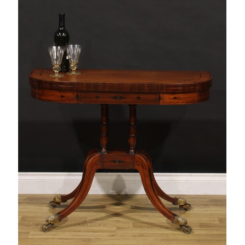 1425 - A Regency mahogany D-shaped card table, hinged top inlaid with naval anchors and enclosing a baize l... 