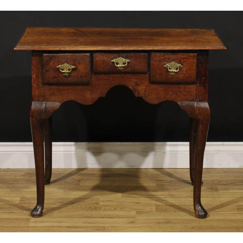 1235 - A George II oak lowboy, oversailing rectangular top above three frieze drawers, engraved brass handl... 