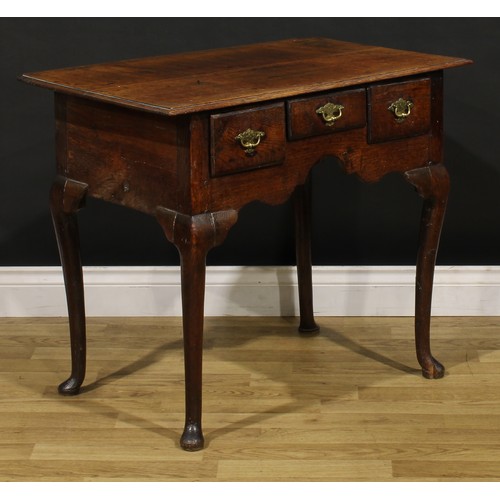 1235 - A George II oak lowboy, oversailing rectangular top above three frieze drawers, engraved brass handl... 