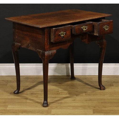 1235 - A George II oak lowboy, oversailing rectangular top above three frieze drawers, engraved brass handl... 