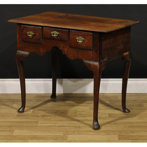 1235 - A George II oak lowboy, oversailing rectangular top above three frieze drawers, engraved brass handl... 