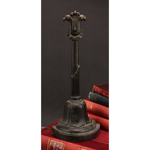 1251 - A post-Regency bronze door stop, cast with lotus, posted handle, demi-lune base, 37cm high, c.1835