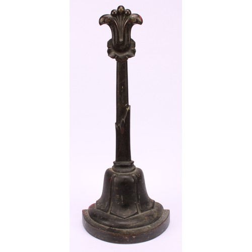 1251 - A post-Regency bronze door stop, cast with lotus, posted handle, demi-lune base, 37cm high, c.1835